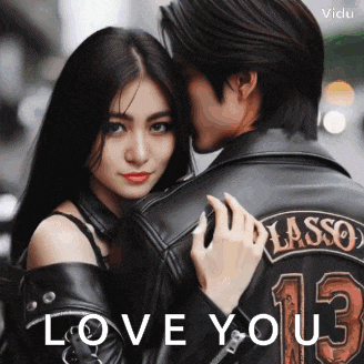 a man in a leather jacket with the number 13 on it kisses a woman on the forehead