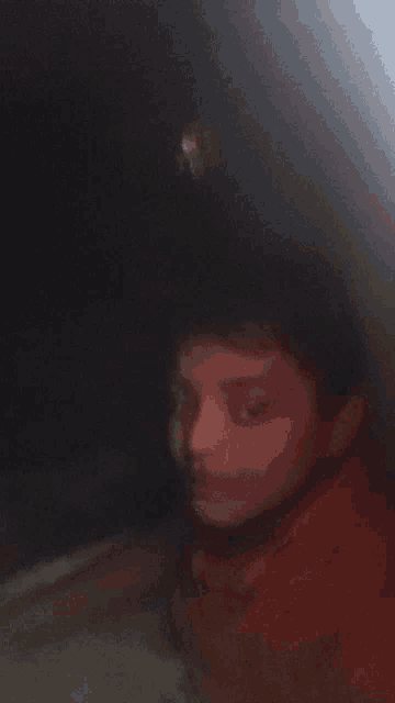 a blurry picture of a person 's face with a red shirt
