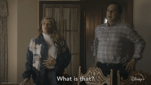 a man and a woman are standing next to each other and the woman is asking what is that