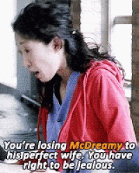 a woman in a red hoodie is talking to another woman in a kitchen .