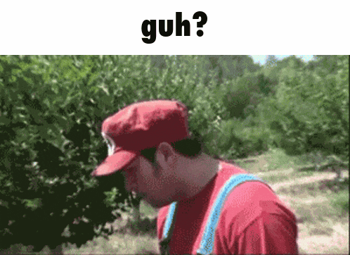 a man wearing a red hat and overalls is standing in front of trees and says guh