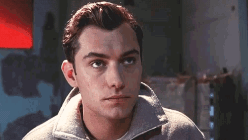 a close up of a man 's face with a zipper on his collar
