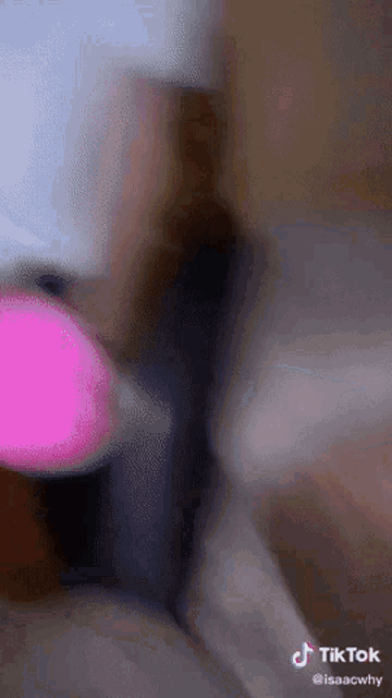 a tiktok video of a person playing with a pink ball