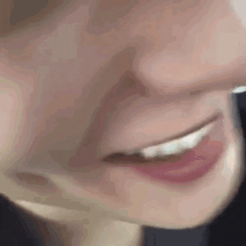 a close up of a woman 's face with a smile on it .