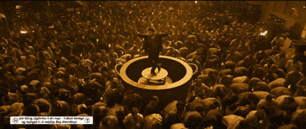 a man in a black shirt stands in front of a crowd with a sign that says ' smoking kills ' on it