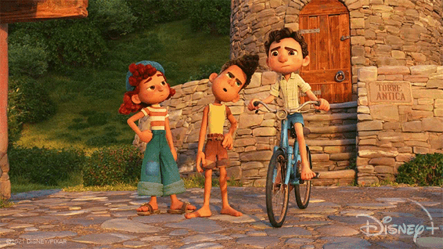 three cartoon characters are standing in front of a stone wall with a sign that says torre antica