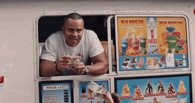 a man is selling ice cream from a truck that says cinco on the side