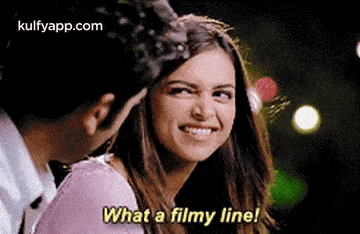 a man and a woman are talking to each other and the woman is smiling and saying what a filmy line .