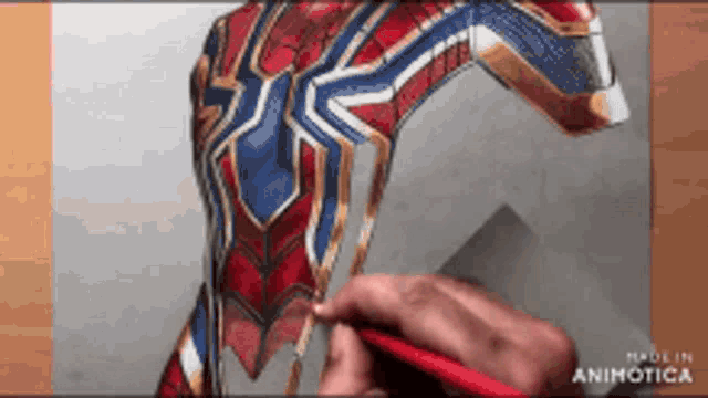 a person is drawing a spiderman costume with a pencil