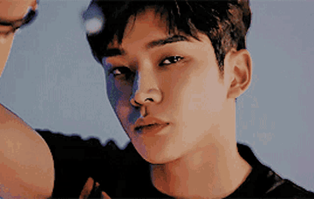 a close up of a young man 's face looking at the camera