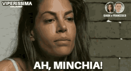 a woman is making a face and says ah minchia !