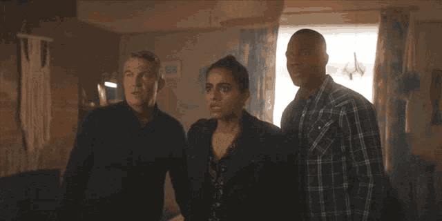 a man and a woman are standing next to each other in a dark room