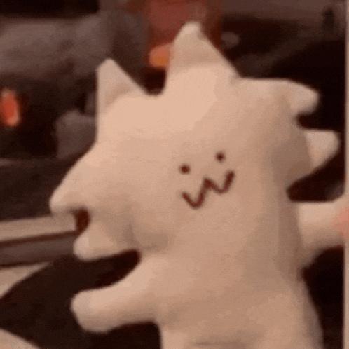 a close up of a stuffed animal with a face on it .
