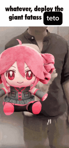 a man is holding a stuffed doll that says teto
