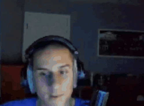 a blurry picture of a man in a blue shirt with his arm up