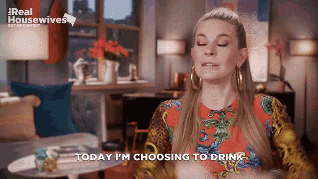 a woman says " today i 'm choosing to drink " in front of a real housewives sign