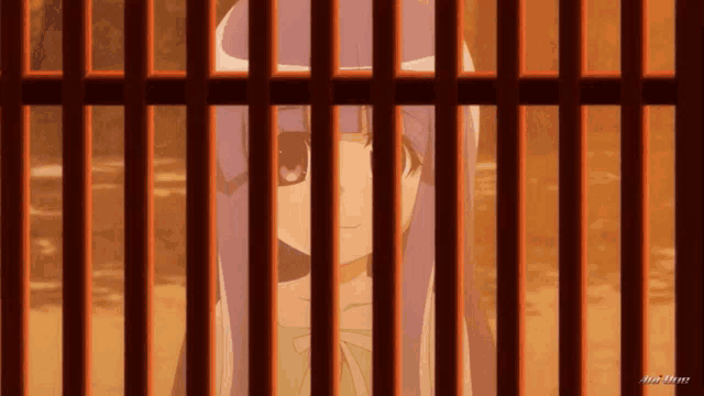 a girl with purple hair is behind bars with a picture of her behind bars