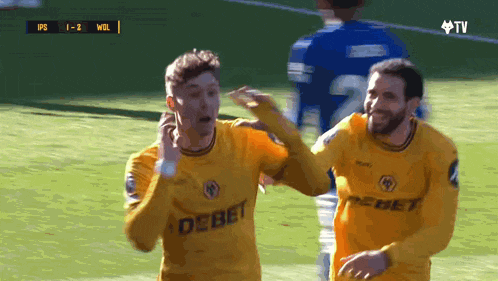 a soccer player wearing a yellow jersey that says debet