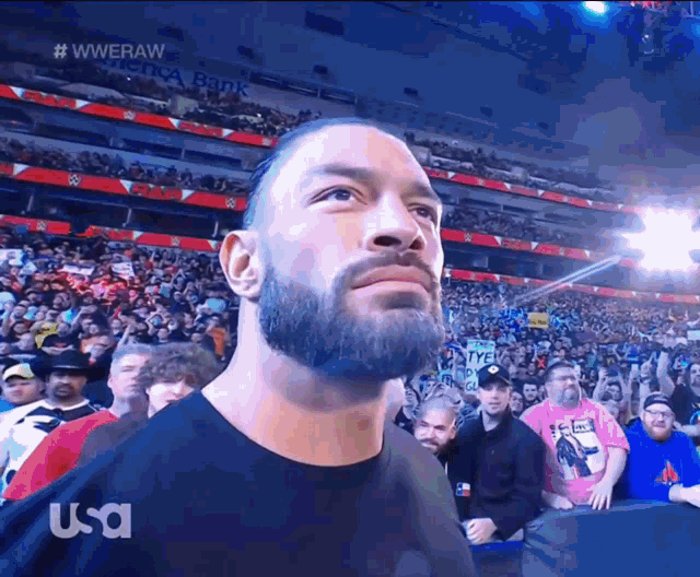 a man in a black shirt stands in front of a crowd with usa written on the bottom of the screen