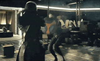 a man in a black suit is fighting another man in a black suit