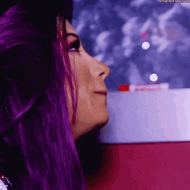 a woman with purple hair is looking up at something