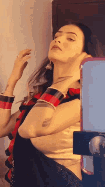 a woman is taking a picture of herself with her phone
