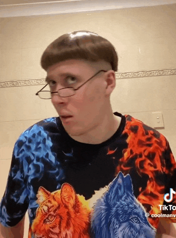 a man wearing glasses and a t-shirt with animals on it