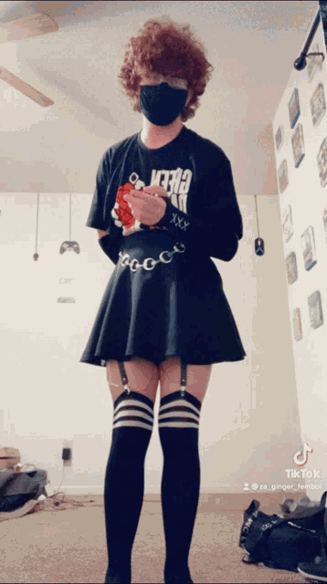 a person wearing a black skirt and knee high socks has a tik tok account