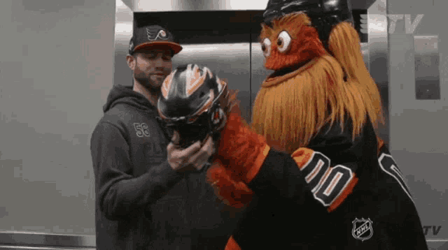 a hockey mascot wearing a number 100 jersey