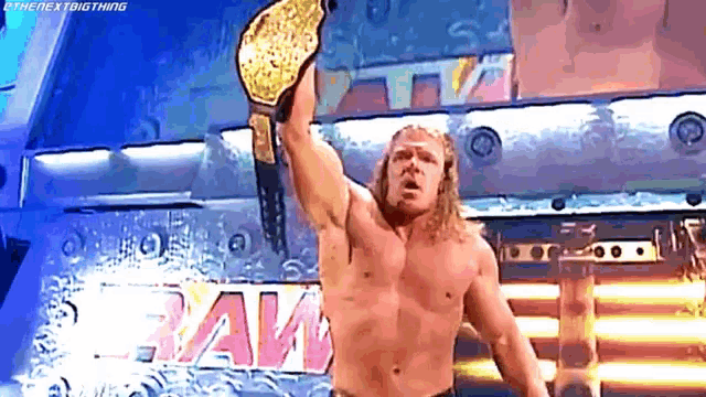 a shirtless wrestler is holding a world heavyweight championship belt in the air .