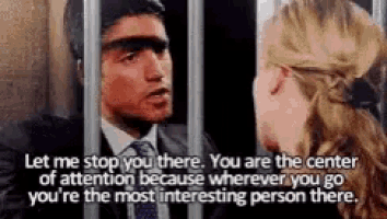 a man in a suit and tie is talking to a woman in a jail cell .