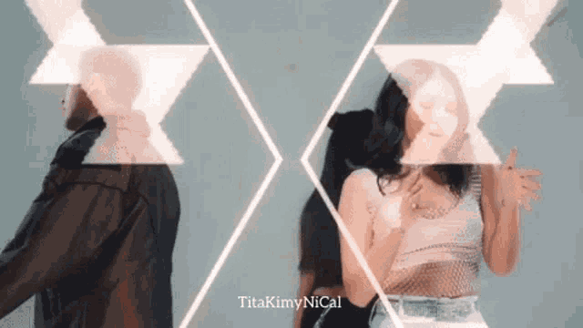 a man and a woman are standing next to each other in a video that says titakiminical