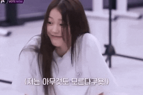 a girl with long hair is making a funny face while laying on the floor .