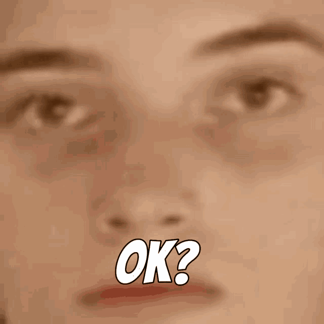 a blurry picture of a man 's face with the words ok written below it