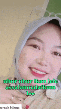 a woman wearing a hijab is smiling with the words " ubur ubur ikan lele assalamualaikum lee " on the bottom