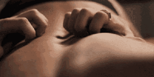 a close up of a person scratching their belly