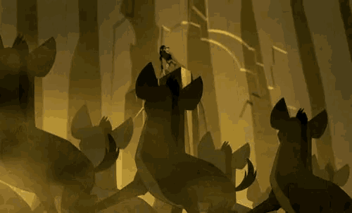 a silhouette of a person standing on top of a cliff surrounded by hyenas