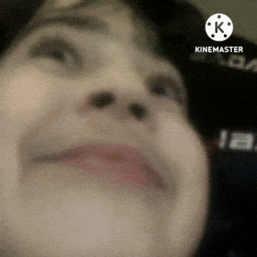 a close up of a person 's face with a k on the bottom