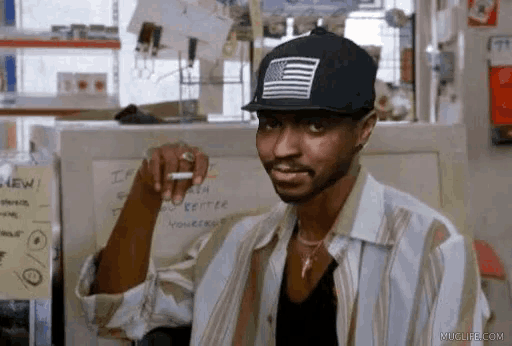 a man wearing a hat with an american flag on it is pointing at something .