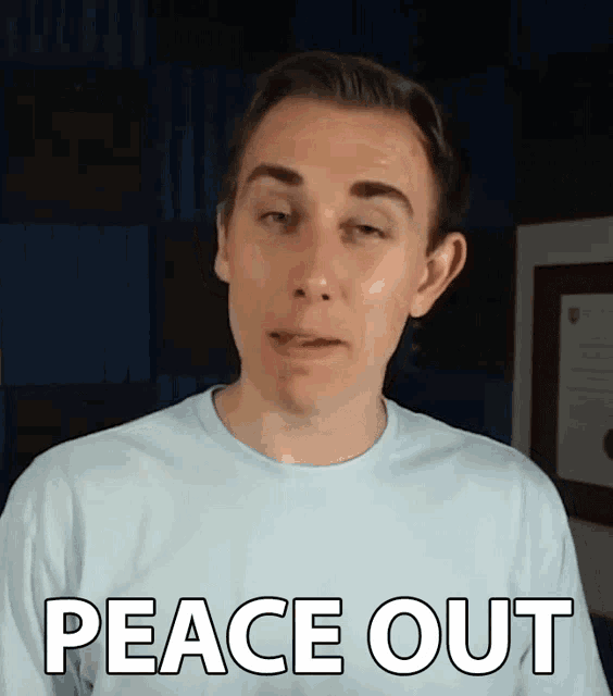 a man in a blue shirt says peace out in white letters
