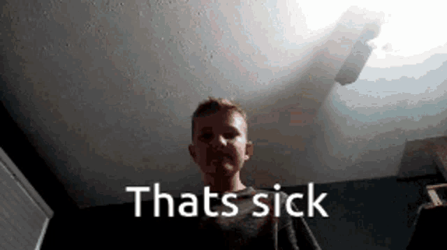 a boy is standing in front of a sign that says " thats sick "