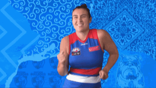 a woman wearing a blue red and white jersey that says afl