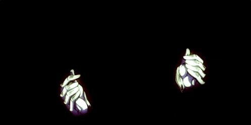 a person 's hand is holding a red object with a pentagram on it