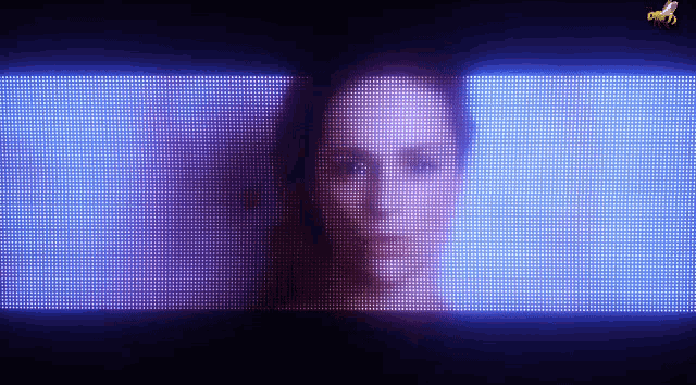 a woman 's face is displayed on a screen with a bee in the background