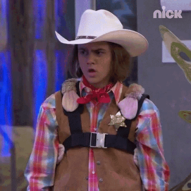 a young man wearing a cowboy hat and vest is holding a stuffed animal .