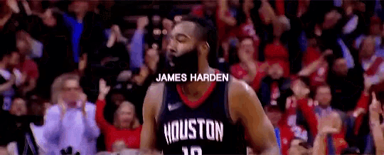a basketball player wearing a houston jersey is standing in front of a crowd