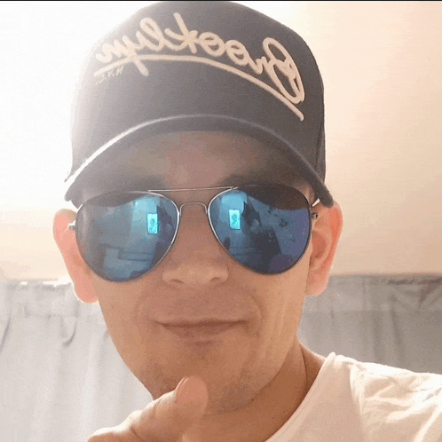 a man wearing sunglasses and a hat that says loyalty