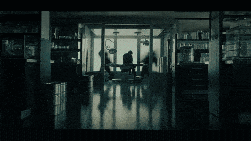 a silhouette of a man standing in a dark room