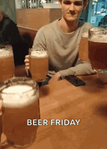 a man sitting at a table holding a glass of beer with the words beer friday written on the bottom