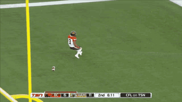 a football player is running on a field with the words touchdown in the upper right corner